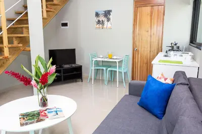 a living room with a couch and a table at Residence Las Dos Palmas in Las Terrenas