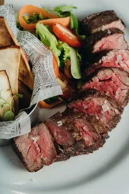 a plate of food with meat and vegetables on it at The Bannister Hotel & Yacht Club by Mint in Santa Bárbara de Samaná