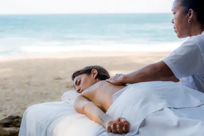 a woman getting a massage on the beach at Natura Cabana Boutique Hotel & SPA by Mint in Cabarete