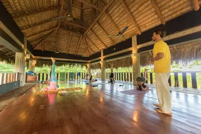 a man and a woman doing yoga in a room at Natura Cabana Boutique Hotel & SPA by Mint in Cabarete