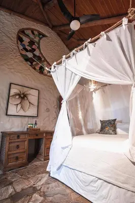 a bedroom with a bed with a mosquito net at Natura Cabana Boutique Hotel & SPA by Mint in Cabarete