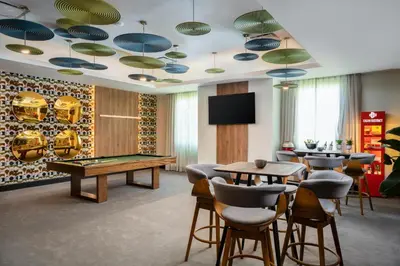 a gaming room with a pool table and ping pong ball at Hodelpa Garden Court in Santiago de los Caballeros