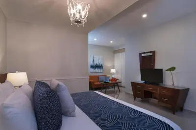 a bedroom with a bed and a flat screen tv at Hodelpa Caribe Colonial in Santo Domingo