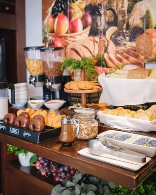 a buffet with various types of bread and other foods at Hodelpa Caribe Colonial in Santo Domingo