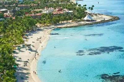an aerial view of a beach with people in the water at Palma Real in Bayahibe