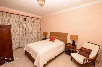 a bedroom with a bed and a chair at Palma Real in Bayahibe