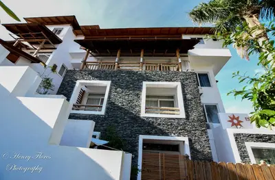 a building with a stone facade with windows at Palma Real in Bayahibe