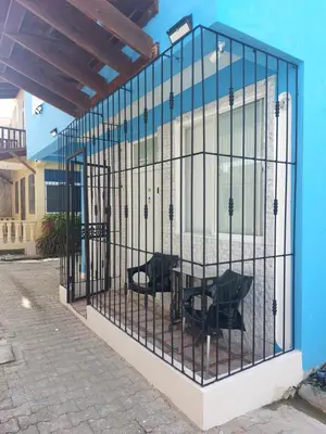 a cage with a table and chairs in it at Apartamento Costa Azul en El Pueblito in San Felipe de Puerto Plata