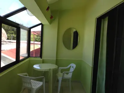 a small table and chairs in a room with a window at Apartment in Plaza Europa in Sosúa