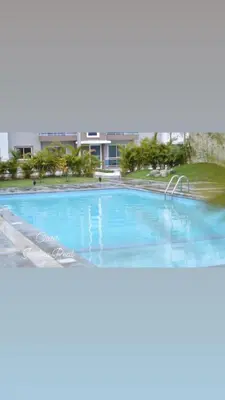 an empty swimming pool in front of a building at Oasis Palma Real santiago, Republica Dominicana in Santiago de los Caballeros