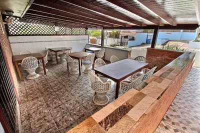 a patio with tables and chairs on a patio at Hotel Garant & Suites in Boca Chica