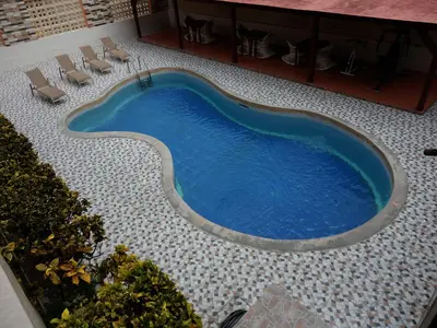 an overhead view of a swimming pool in a building at Hotel Garant & Suites in Boca Chica