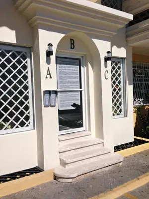 a building with a sign on the front of it at Caribbean Seaview apart Malecon Santo Domingo in Santo Domingo