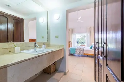 a bathroom with a sink and a bed in a room at Private & Luxury Apartment Cocotal in Gated & Secured Community in Punta Cana