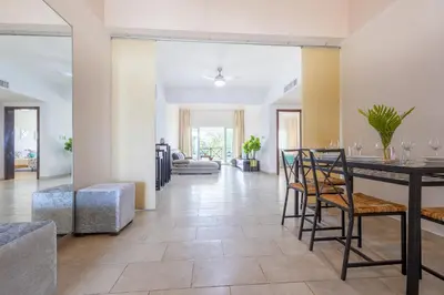 a dining room and living room with a table and chairs at Private & Luxury Apartment Cocotal in Gated & Secured Community in Punta Cana