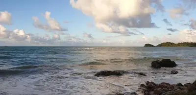 a view of the ocean with rocks in the water at Hotel Atlantis in Las Terrenas