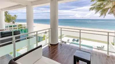 a balcony with a view of the beach and the ocean at Watermark Luxury Oceanfront Residences in Cabarete