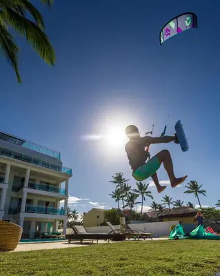 a man flying a kite in the air at Watermark Luxury Oceanfront Residences in Cabarete