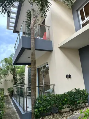 a palm tree in front of a building at SFMverdana Rental in San Francisco de Macorís