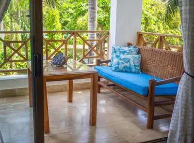 a porch with a table and a couch and a table at Monserrat Residences in Las Terrenas