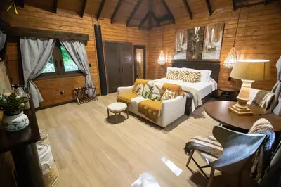 a living room with a bed and a couch at Platon Ecolodge in Santa Cruz de Barahona