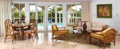 a living room with a table and chairs at 3br Villa with Vip Access - All Inclusive Program with Alcohol Included in San Felipe de Puerto Plata