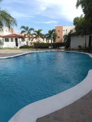 a large swimming pool with blue water at Paradise 3 cerro Altos in Santiago de los Caballeros