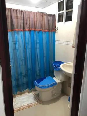 a bathroom with a toilet and a sink at Paradise 3 cerro Altos in Santiago de los Caballeros