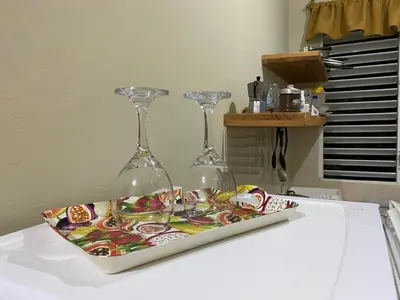 two wine glasses sitting on top of a table at Villa Coconut in La Verita