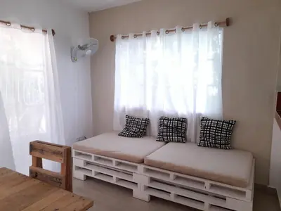 a room with a bench in front of a window at Villa Coconut in La Verita
