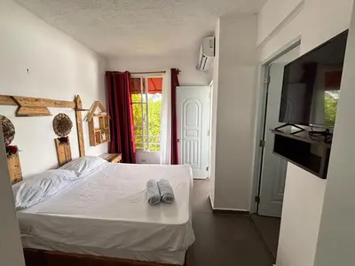 a bedroom with a bed with two slippers on it at Villa Coconut in La Verita