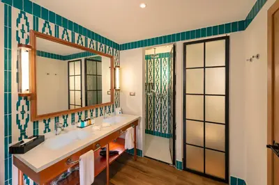 a bathroom with two sinks and a mirror at Ocean el Faro Resort - All Inclusive in Punta Cana
