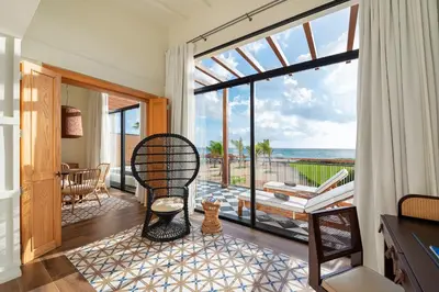 a living room with a view of the ocean at Ocean el Faro Resort - All Inclusive in Punta Cana