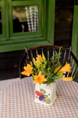 a vase filled with flowers sitting on a table at Villa Pajon Eco Lodge in Constanza