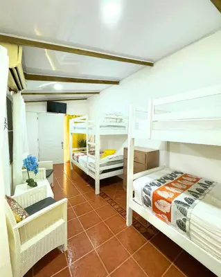 a room with two bunk beds and a couch at Hotel Santo Cerro Natural Park in Santo Cerro