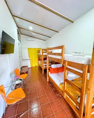 a dorm room with bunk beds and a tv at Hotel Santo Cerro Natural Park in Santo Cerro