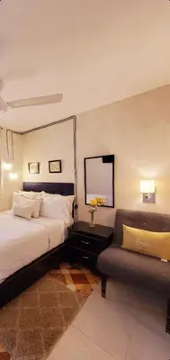 a hotel room with a bed and a couch at Hotel Santa Clara in San Fernando de Monte Cristi