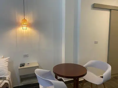 a room with a table and chairs and a bed at Apartamentos Magallanes Bayahibe in Bayahibe