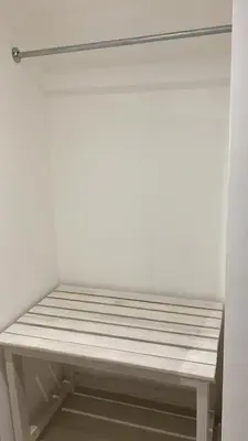 a bench in a closet with a white wall at Apartamentos Magallanes Bayahibe in Bayahibe