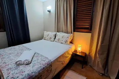 a small bedroom with a bed and a lamp at Casa Villa Anacahuita in Jarabacoa