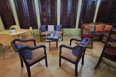 a living room with chairs and a table and a couch at Casa Villa Anacahuita in Jarabacoa