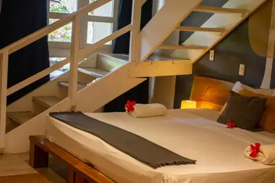 a bedroom with a bed with red bows on it at Afreeka Beach Hotel in Las Terrenas