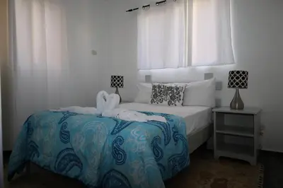 a bedroom with a bed with a stuffed animal on it at Aparta-Hotel Villa Baya in Bayahibe