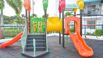 a playground with a slide and slides at Dolce Villas at Harmony 2 in Santiago de los Caballeros
