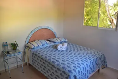 a bedroom with a bed with two towels on it at Puerto Blanco Marina & Hotel in Puerto de Luperon