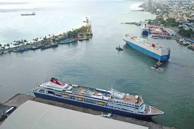 a large cruise ship is docked in a harbor at Cerca del Mar, Obelisco Hembra y Zona Colonial in Santo Domingo