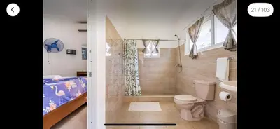 a bathroom with a shower and a toilet and a tub at Villa Vista azul Sosua in Sosúa