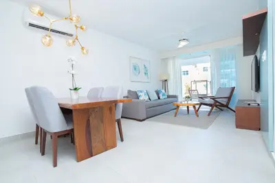 a living room with a table and a couch at Presidential Suites Cabarete - Room Only in Cabarete