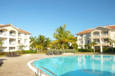 a swimming pool in front of some buildings at Pez 106 in Bayahibe