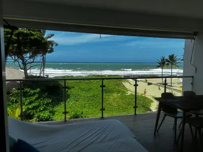 a bedroom with a view of the beach from a window at Residencial Mañanero in Cabarete